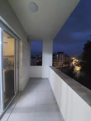 a balcony with a view of the city at night at New zarqa20 km from Amman in Az Zarqa