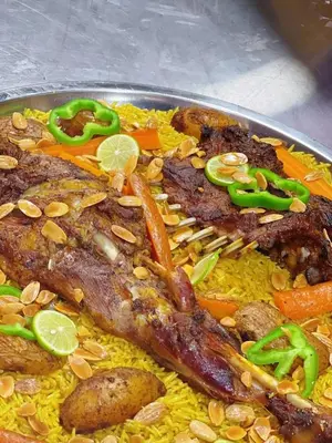 a plate of food with rice and meat and vegetables at دبه حانوت هاوس in Raʼs an Naqb