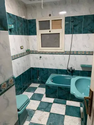 a bathroom with a tub and a toilet and a sink at دبه حانوت هاوس in Raʼs an Naqb
