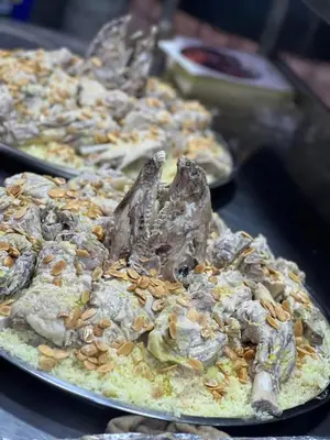 a pizza with mushrooms and nuts on a table at دبه حانوت هاوس in Raʼs an Naqb