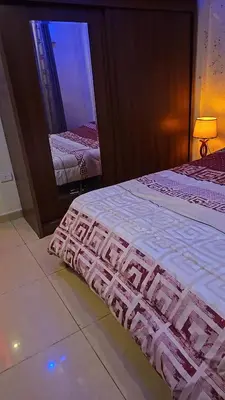 a bedroom with two beds and a mirror at Al Tamimi Furnished Apartments in Amman