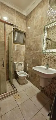 a bathroom with a toilet and a sink at Al Tamimi Furnished Apartments in Amman