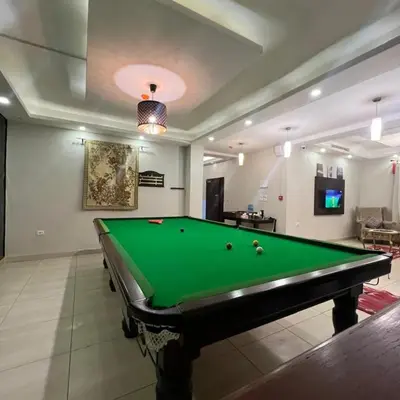a billiard room with a pool table in a room at سهول الكرمل للأجنحة والشقق الفندقية in Amman