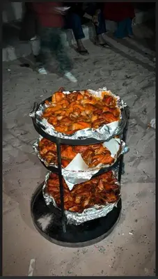 a stack of three trays of food on a table at Aethera Sky Retreat Wadi Rum in Wadi Rum