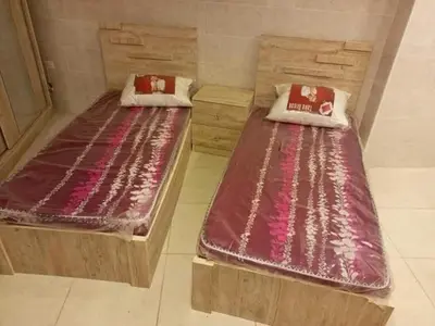 two beds sitting on the floor in a room at sliver apartment in Bayt Raʼs