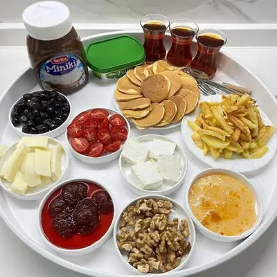 a white plate with different types of food on it at rafat house in Amman