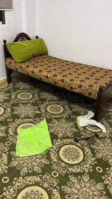 a couch sitting on top of a floor with a rug at rafat house in Amman