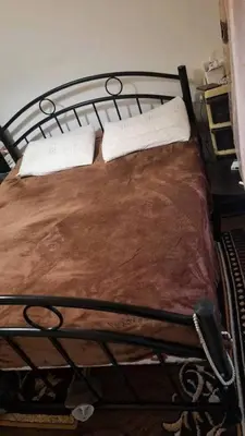 a metal bed with two white pillows on it at rafat house in Amman