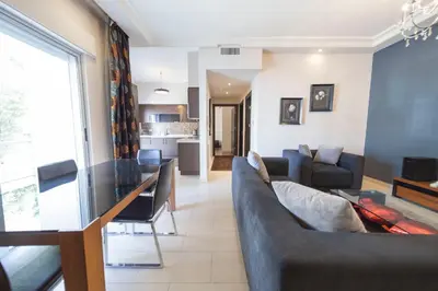 a living room with a couch and a table at Tower Apartment in Amman