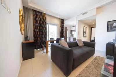 a living room with a couch and a table at Tower Apartment in Amman