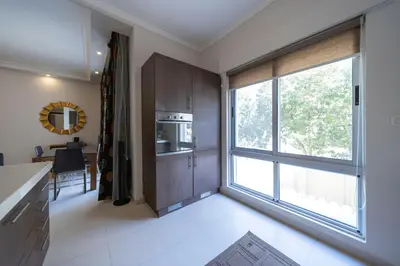a kitchen with a large window next to a table at Tower Apartment in Amman
