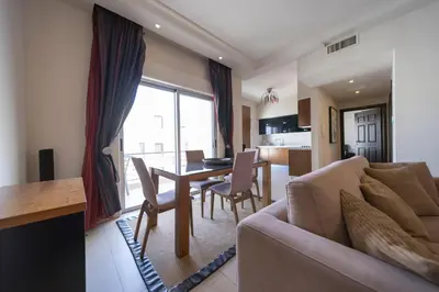 a living room with a couch and a table at Tower Apartment in Amman