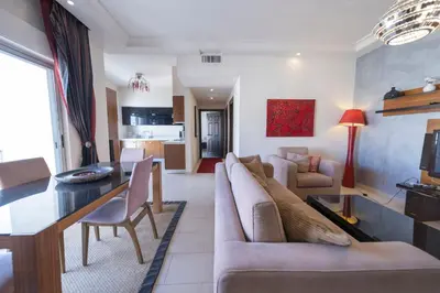 a living room with a couch and a table at Tower Apartment in Amman