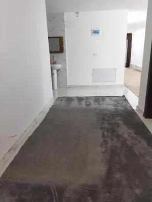 an empty room with a large rug on the floor at شقة مفروشة في عجلون رأس منيف in Ajloun