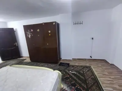 a living room with a white couch and a wall at شقة مفروشة في عجلون رأس منيف in Ajloun