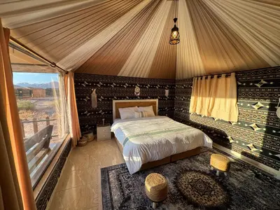 a bedroom with a bed in a tent at Zahara rum camp & Boutique Resort in Disah