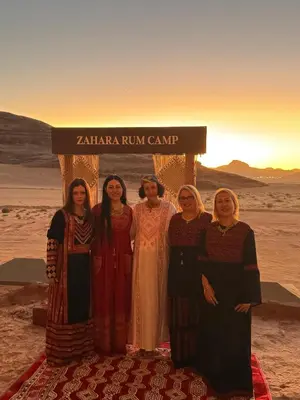 a group of people standing in front of a sign at Zahara rum camp & Boutique Resort in Disah
