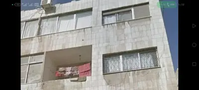 a tall brick building with windows on it at بيت الحجر in Amman