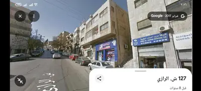 a view of a street with cars parked on the street at بيت الحجر in Amman