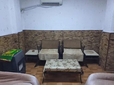 a living room with two chairs and a couch at بيت الحجر in Amman