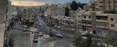 a view of a city street with cars and buildings at بيت الحجر in Amman