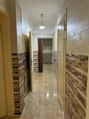a hallway with brick walls and a hallway with a door at Decapolis 8 in Irbid