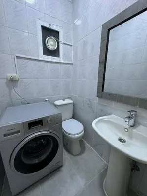 a bathroom with a washing machine and a sink at Decapolis 8 in Irbid