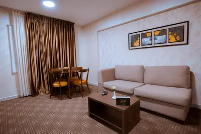 a living room with a couch and a table at Rawa Luxury Hotel Suites in Amman