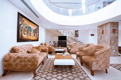 a living room with leather furniture and a skylight at Rawa Luxury Hotel Suites in Amman