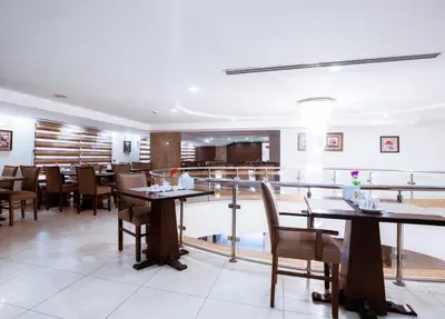 a restaurant with tables and chairs in a room at Rawa Luxury Hotel Suites in Amman