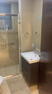a bathroom with a sink and a shower at Luxury home Abdoun complex in Amman