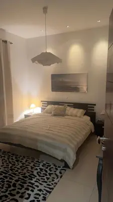 a bedroom with a large bed with a black and white rug at Luxury home Abdoun complex in Amman