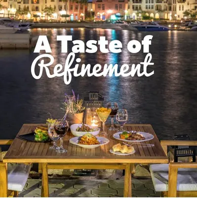 a table with plates of food and wine glasses at Talabay two bedroom umniah pool in Aqaba