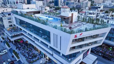 an overhead view of a building in a city at Swisstouches Hotel Amman in Amman