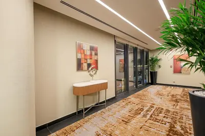 a hallway with a table and a painting on the wall at Swisstouches Hotel Amman in Amman