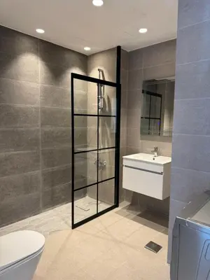 a bathroom with a toilet and a sink at DAMAC Pool View Penthouse in Amman