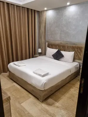 a bedroom with a large bed in a room at unique 2bedroom at abdoun 001 in Amman
