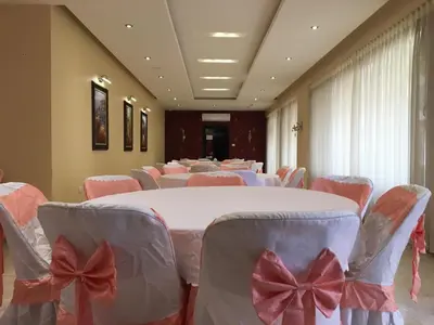 a room with tables and chairs with bows on them at Montana Residence in Amman