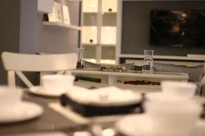 a table with plates and glasses on top of it at Montana Residence in Amman