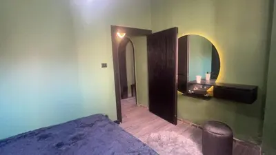 a bedroom with a bed and a mirror on the wall at Art loft in Amman