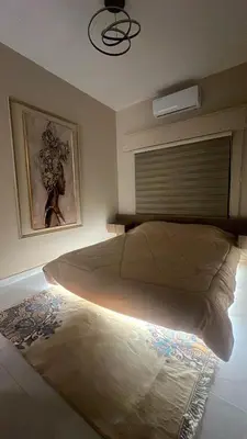 a bedroom with a large bed with a window at Art loft in Amman