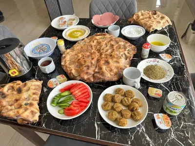 a table with a bunch of food on it at Mountain Echo Inn in Taiyiba