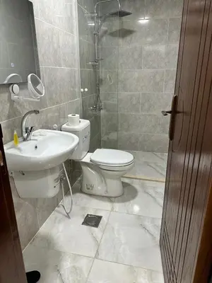 a bathroom with a toilet and a sink at Mountain Echo Inn in Taiyiba