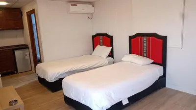 a room with two beds in a room at Rum Pillars Camp in Disah