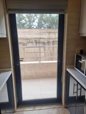 a sliding glass door in a kitchen with a balcony at unique 2bedroom at abdoun 006 in Amman