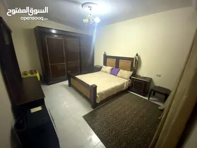 a small bedroom with a bed and a rug at شقة للايجار السنوي in Amman