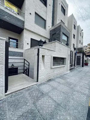a building with a walkway in front of it at Sweet Home In Amman - Family Friendly in Amman