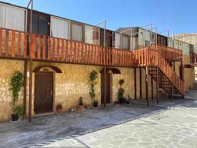 a building with a staircase on the side of it at Dana Trail Hotel in Dana