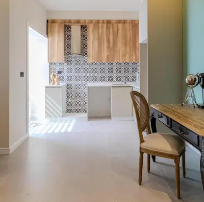 a kitchen with a table and a chair in a room at Flamant Apartments in Amman