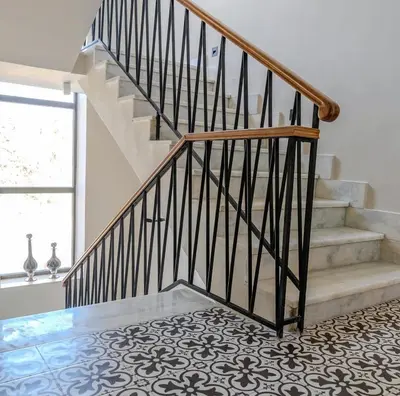 a staircase with a black and white tile floor at Flamant Apartments in Amman